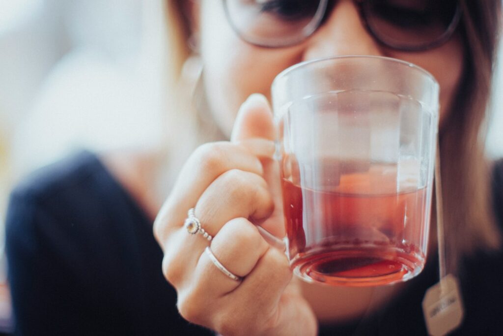 Woman calmly drinking tea, for an article on whether IBS can be cured