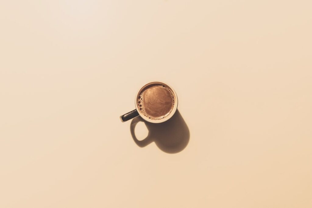 A cup of coffee on a table, for an article on coffee and IBS