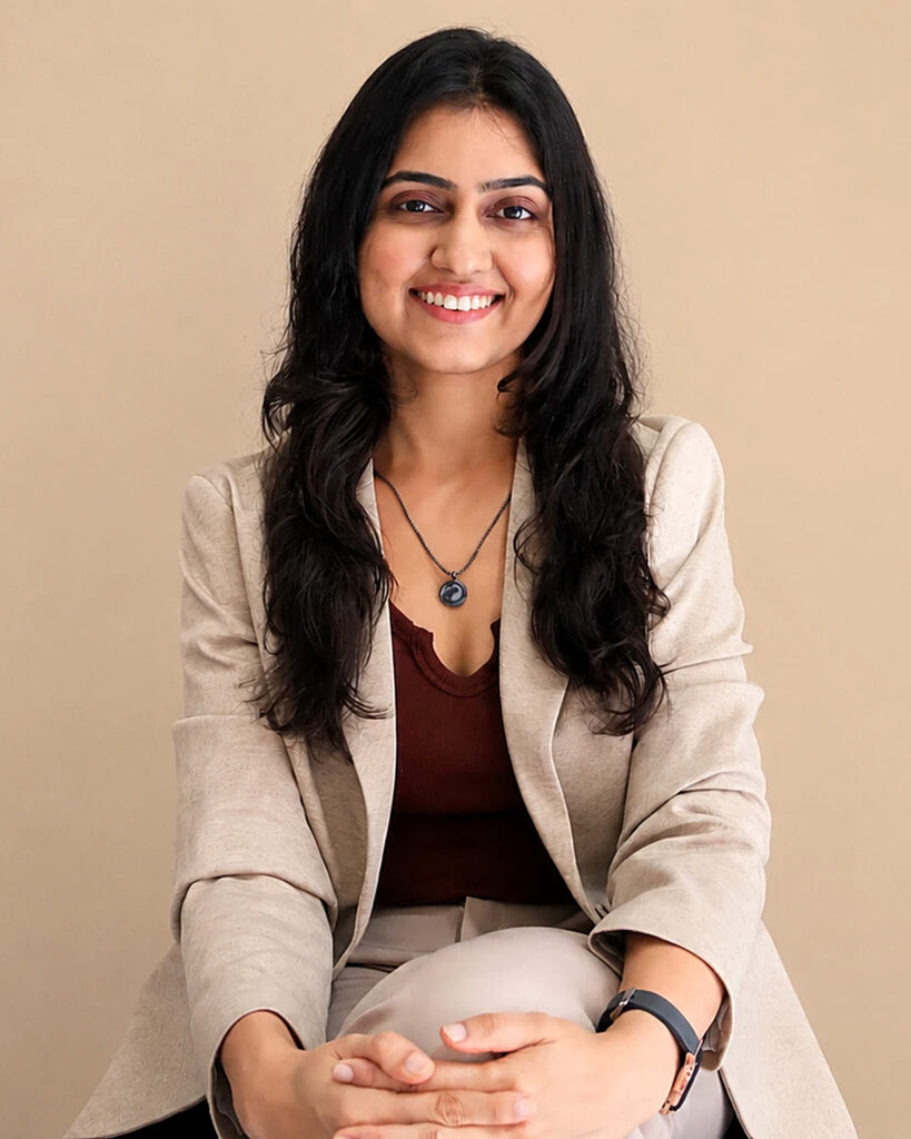 Dt. Hashika Vyas, dietitian, smiling and seated in a beige blazer