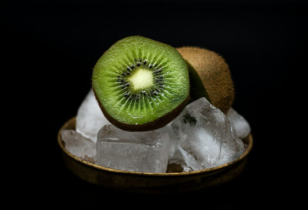 Halved green kiwifruit, a food that may help ease Ozempic constipation (photo by blackieshoot on Unsplash)