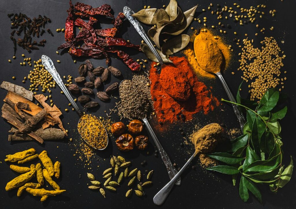 Bowls of Indian spices used in low FODMAP Indian food (photo by Anju Ravindranath on Unsplash)