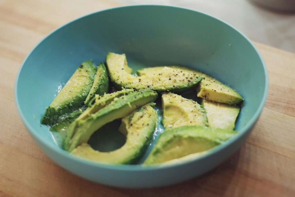 Sliced ripe avocado in a bowl, showing a small low FODMAP portion for IBS