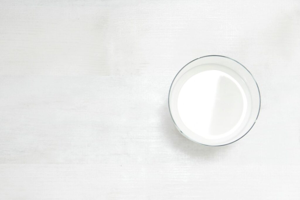 Glass of milk on a table, for an article on lactose and IBS