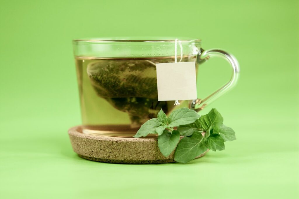 Glass mug of fresh mint leaves, for an article on peppermint oil for IBS