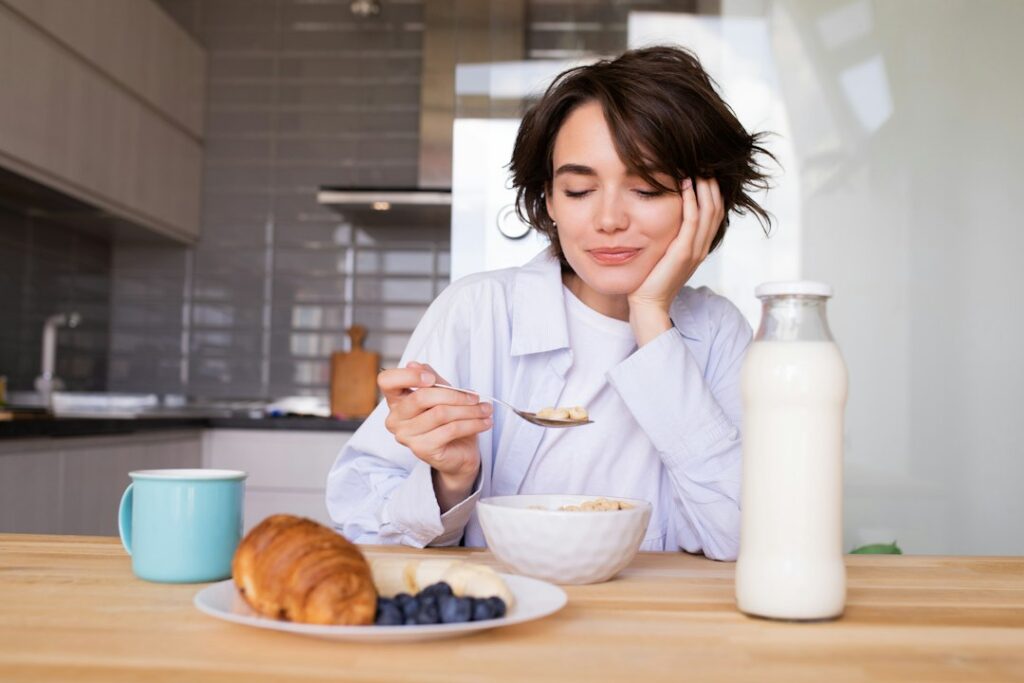 Woman eating a calm meal at a table, supporting the gut-brain axis